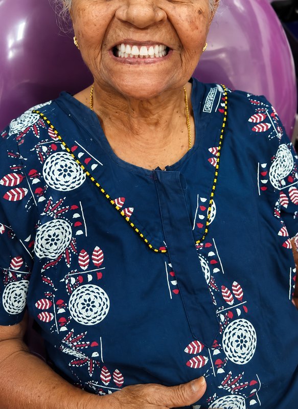 Patient smiling after full denture treatment at Shanthi Dental Clinic